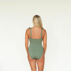 Person wearing a green swimsuit on a white background