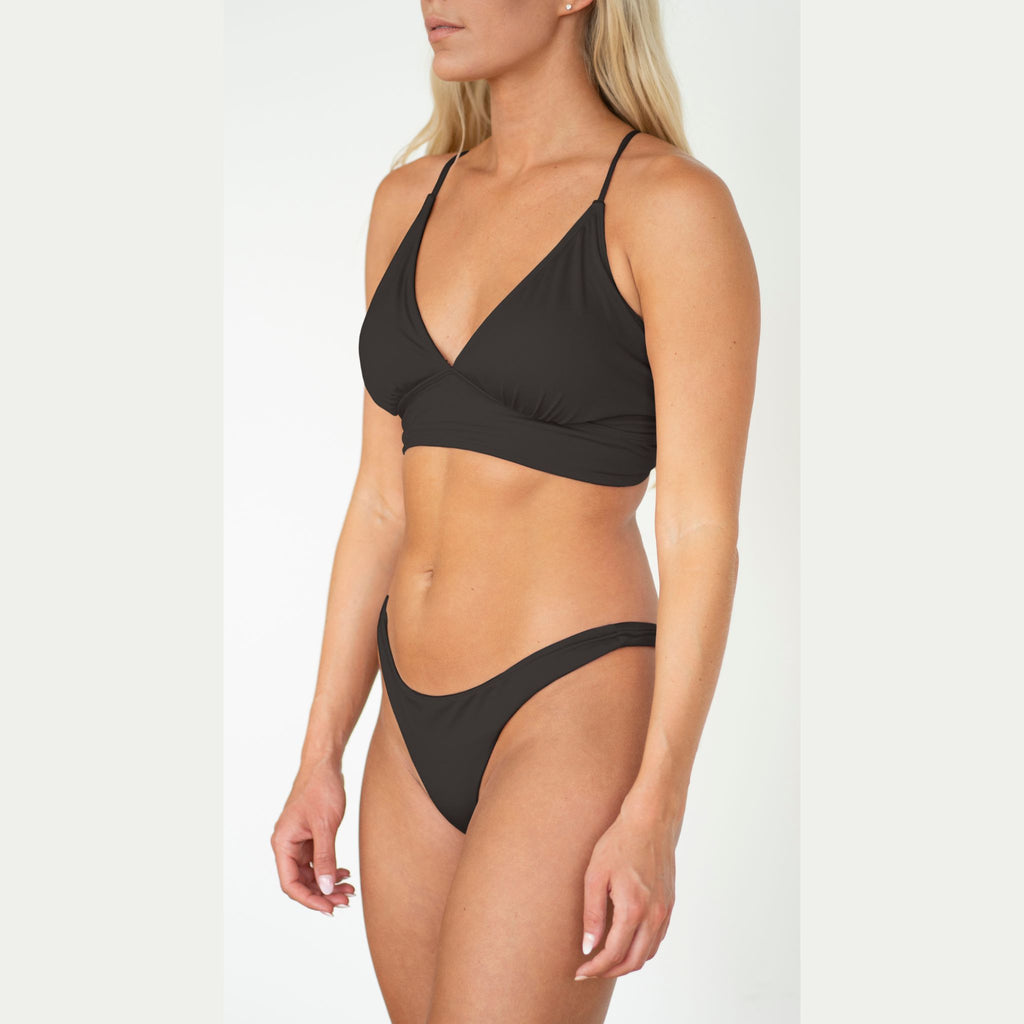 Black bikini set worn by a model on a white background