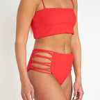 Red bikini set on a plain background