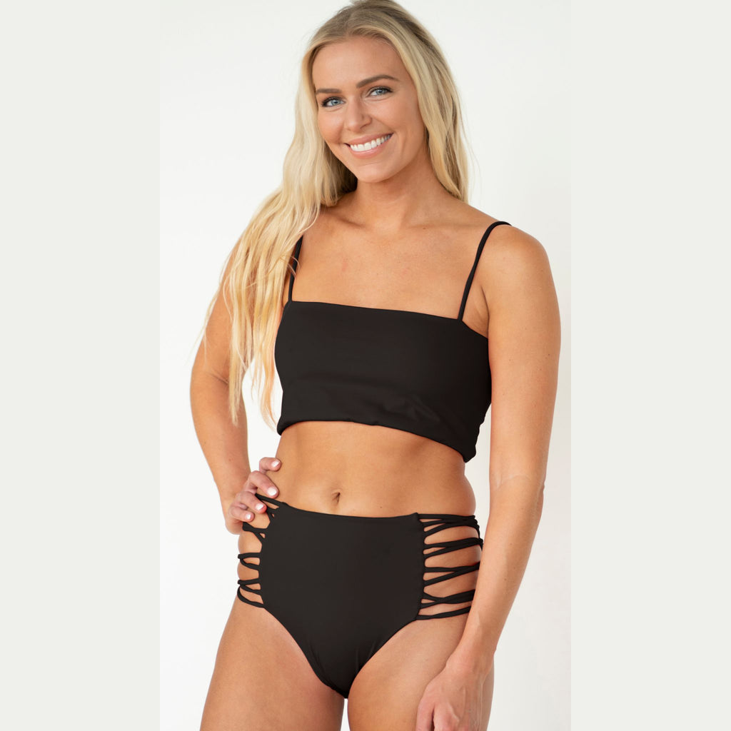 Woman wearing a black bikini with a white background