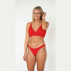 Woman wearing a red bikini set on a white background