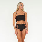 Woman wearing a black bikini with a white background